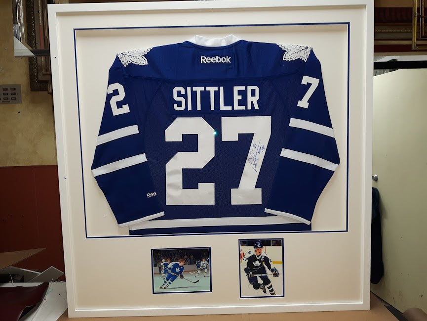 Darryl Sittler autographed Toronto Maple Leafs jersey custom framed in shadowbox with team photos and blue accent mat by Framing & Display.
