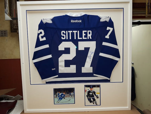 Darryl Sittler autographed Toronto Maple Leafs jersey custom framed in shadowbox with team photos and blue accent mat by Framing & Display.